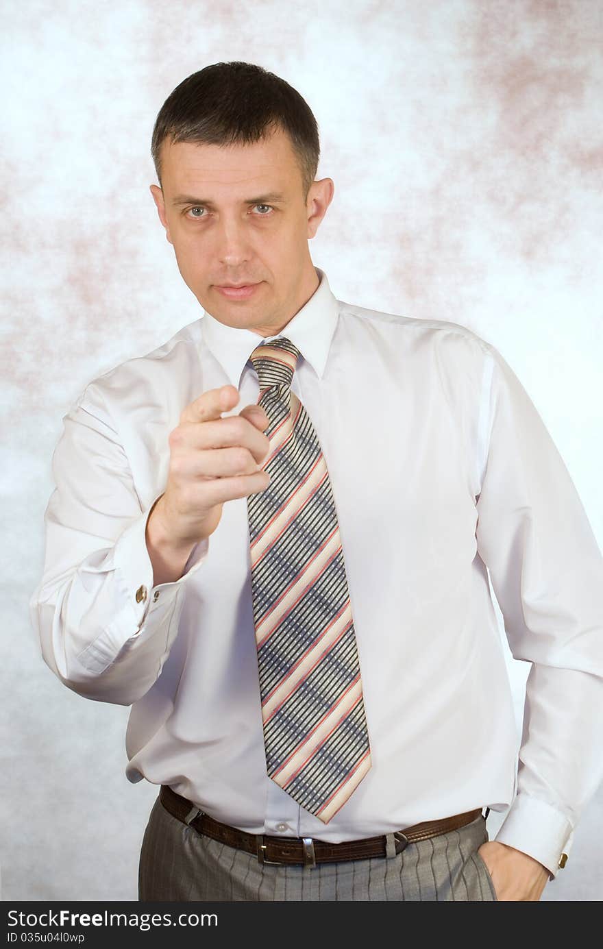 Portrait of the serious businessman on an abstract background