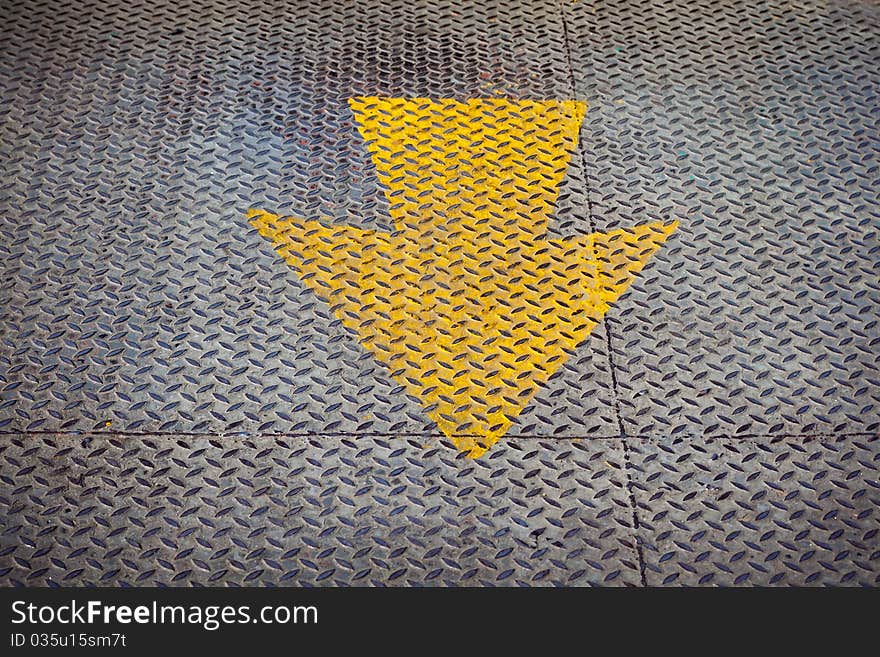 Yellow arrow Paint on steel floor plate