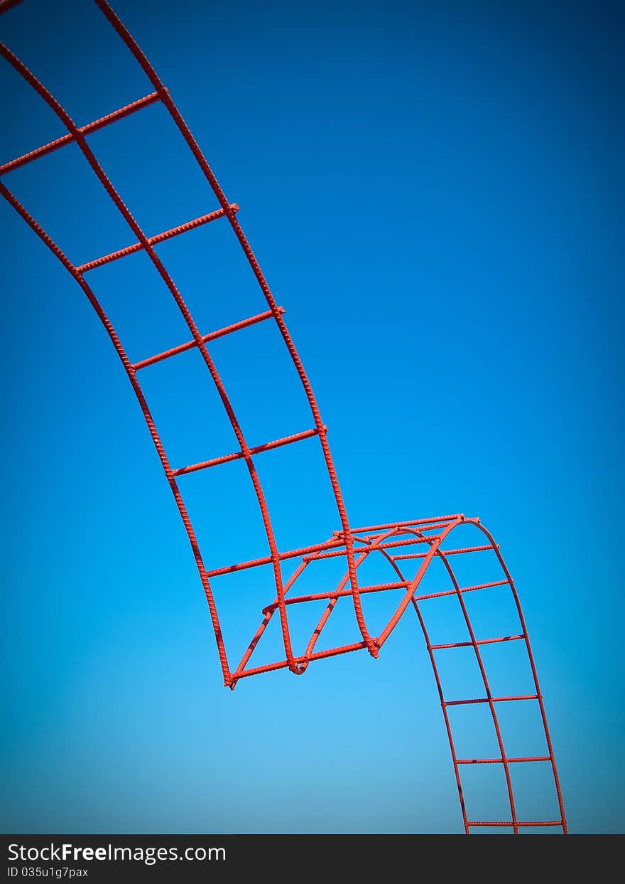 Bending steel painted red and blue sky background