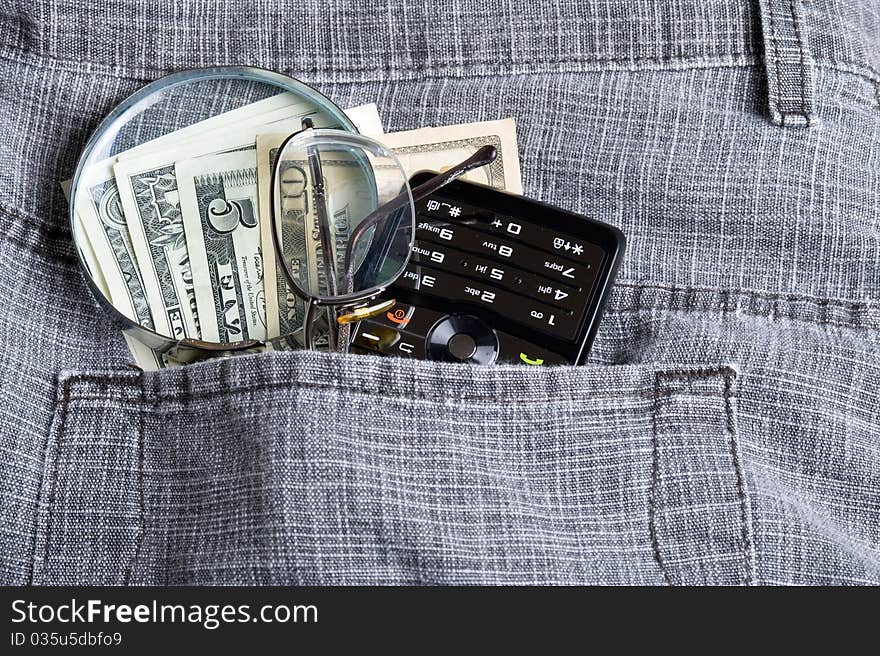 Cell phone in jeans pocket and dollar. Cell phone in jeans pocket and dollar