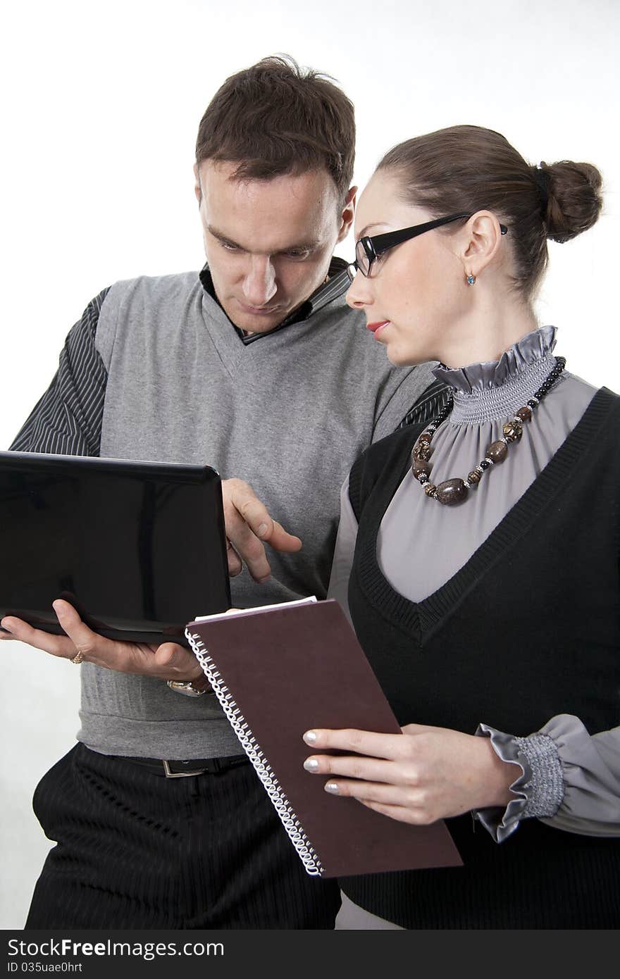 Businessman with the computer and businesswoman at a meeting. Businessman with the computer and businesswoman at a meeting.