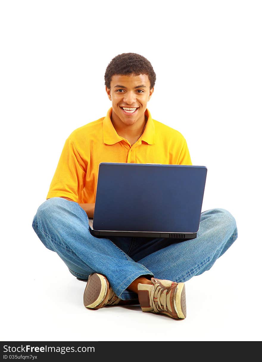 Happy young man working on a laptop, isolated against white background