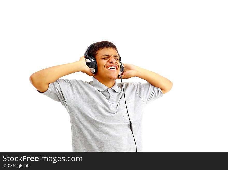 Young happy man listening to music and singing