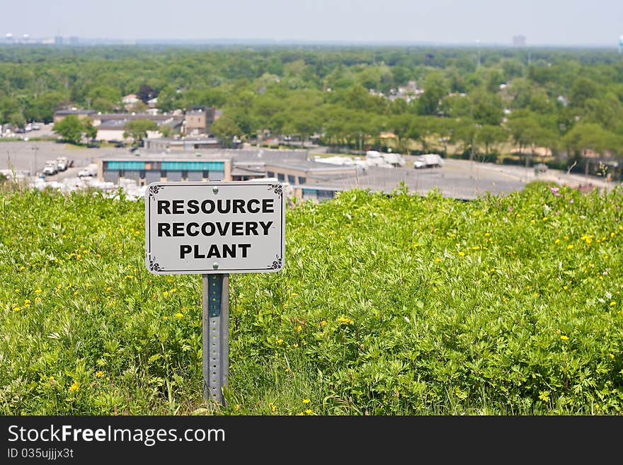 Image of the signpost to the resource (recycling) plant, with the plant in the background. Image of the signpost to the resource (recycling) plant, with the plant in the background