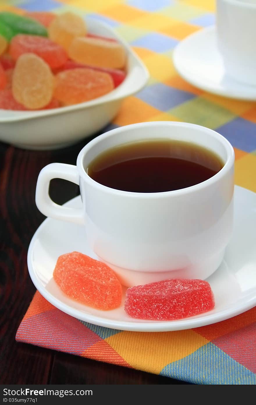 Cup of tea and fruit candy.