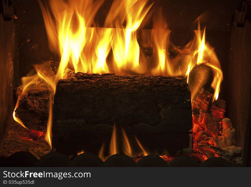 Fire in the fireplace, with flames and smoke consumed the wood