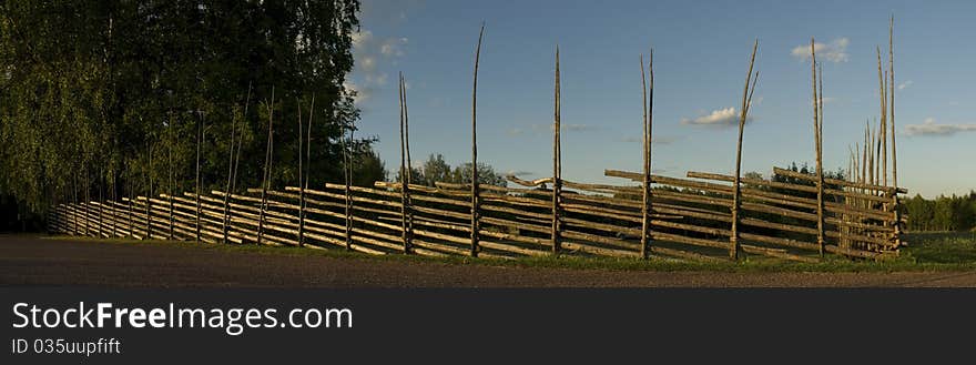 Old swedish wooden fence in the sunset. Old swedish wooden fence in the sunset