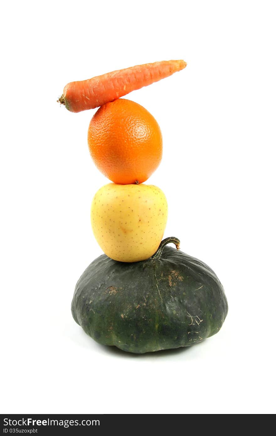 Tower of vegetables and fruits isolated on white background