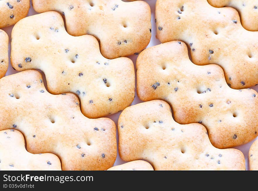 Small shaped browned crisp biscuits as tile background