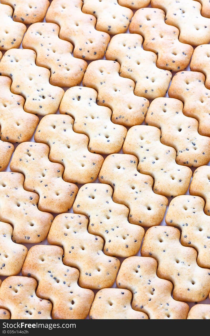 Shaped browned crisp biscuits as tile background