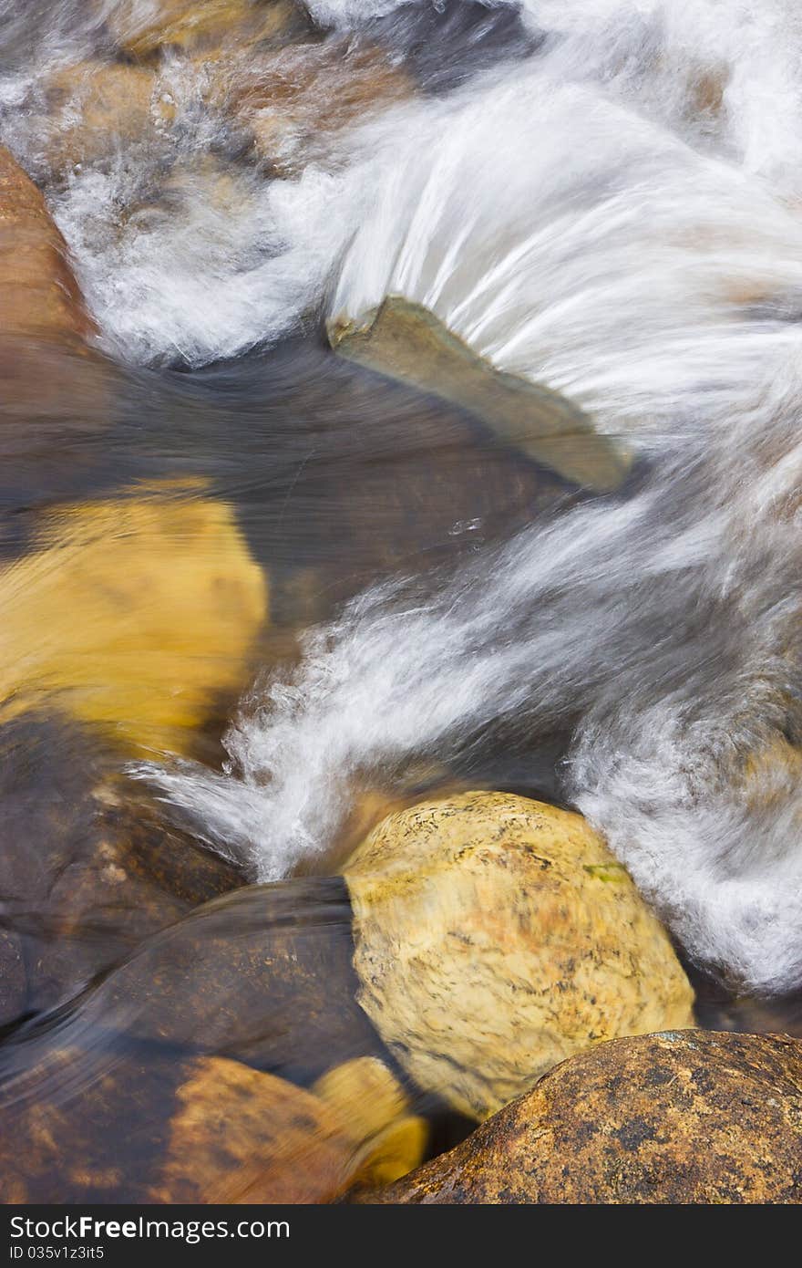 Shallow river water rushing over rocks. Shallow river water rushing over rocks.