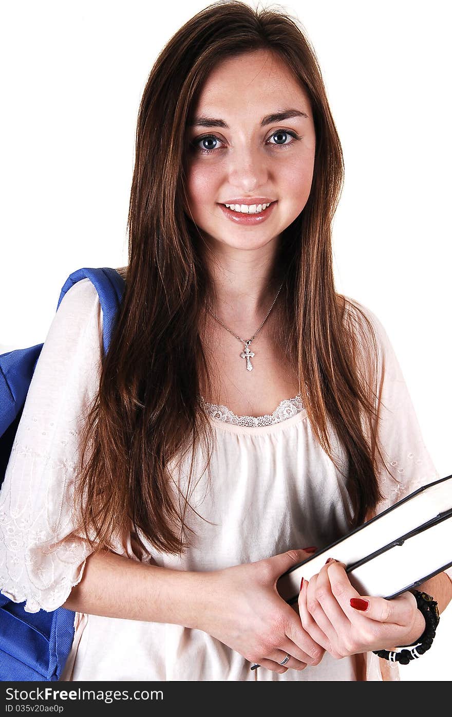 A pretty teenager in a beige blouse and a blue backpack over her shoulder
and books in her hand, standing in the studio for white background. A pretty teenager in a beige blouse and a blue backpack over her shoulder
and books in her hand, standing in the studio for white background.