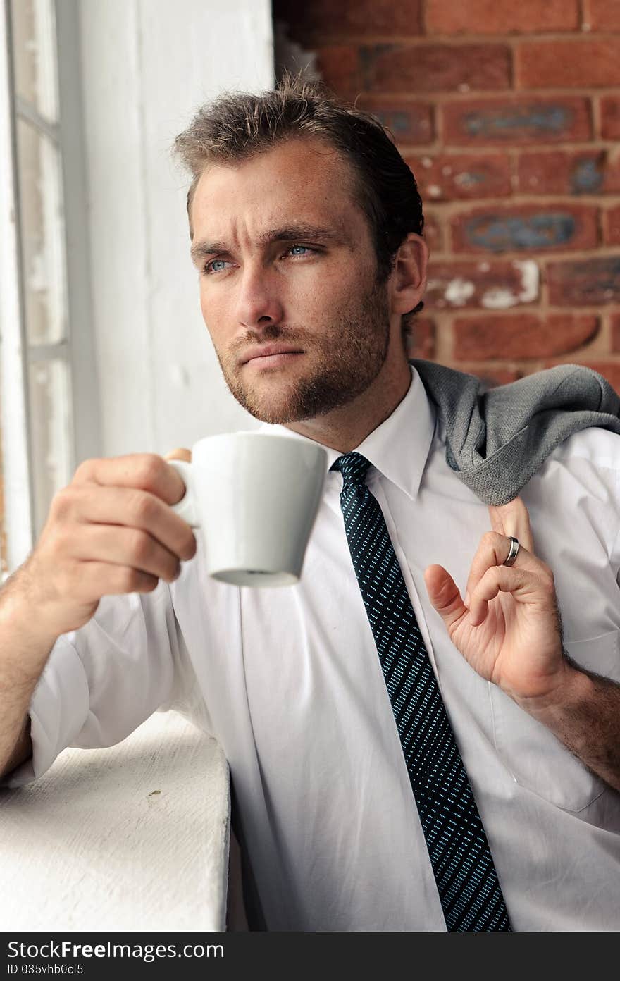 Man looks out the window thoughfully, nice portrait of a businessman. Man looks out the window thoughfully, nice portrait of a businessman