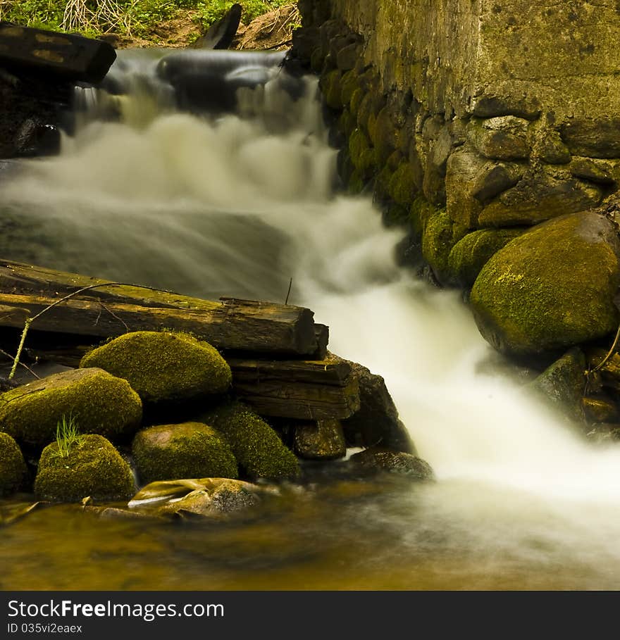 Impetuous stream framed by mossy stones. Impetuous stream framed by mossy stones