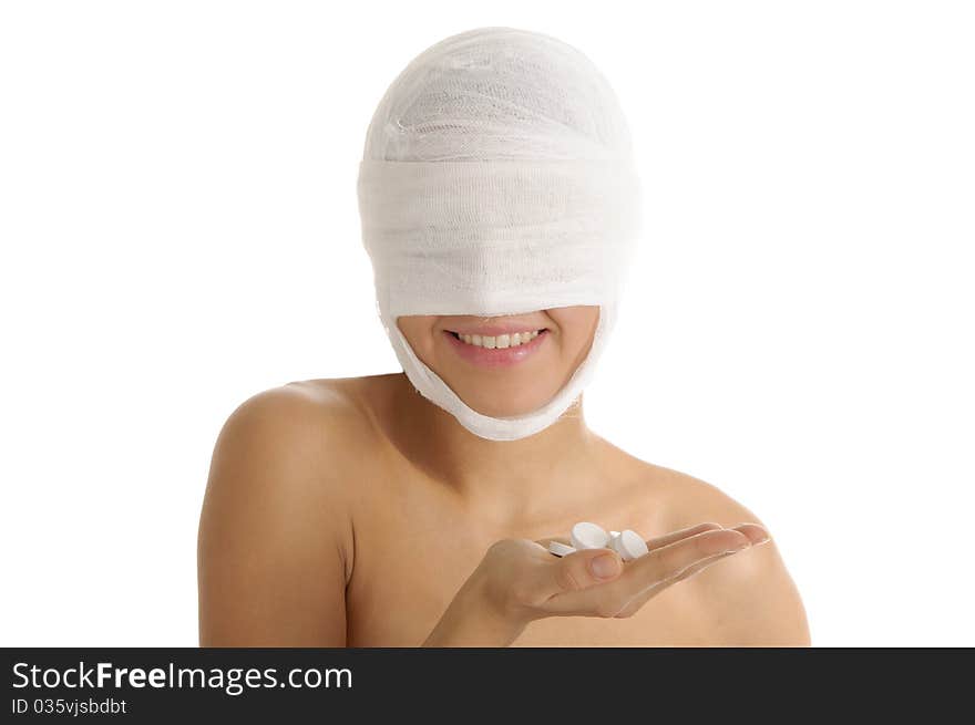 Woman with bandaged head with tablets on palm