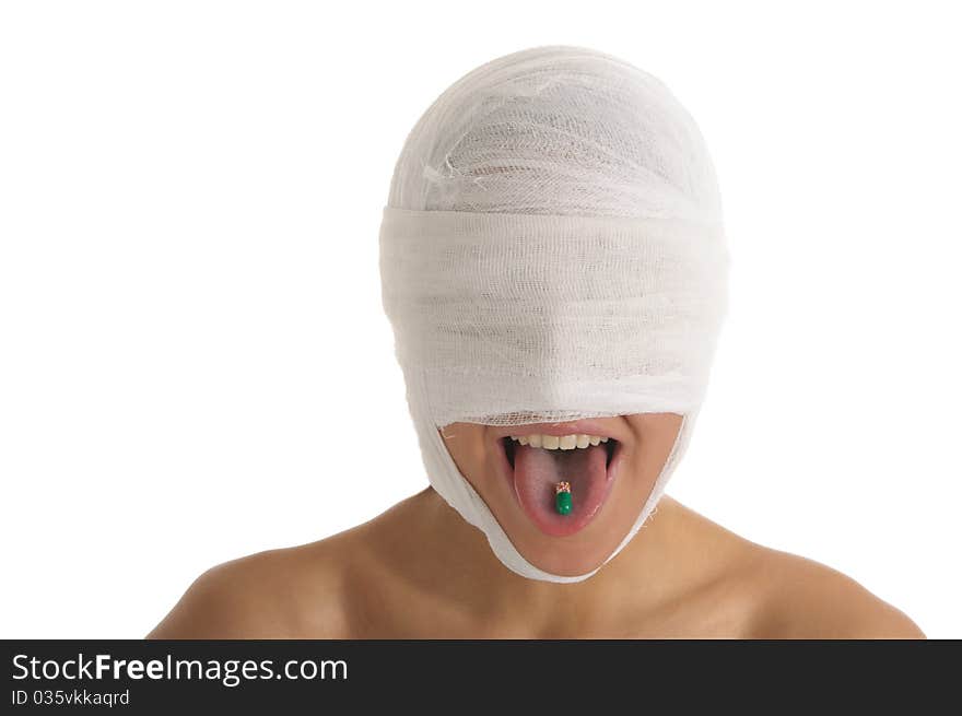 Young woman with bandaged head with tablet in tongue isolated in white