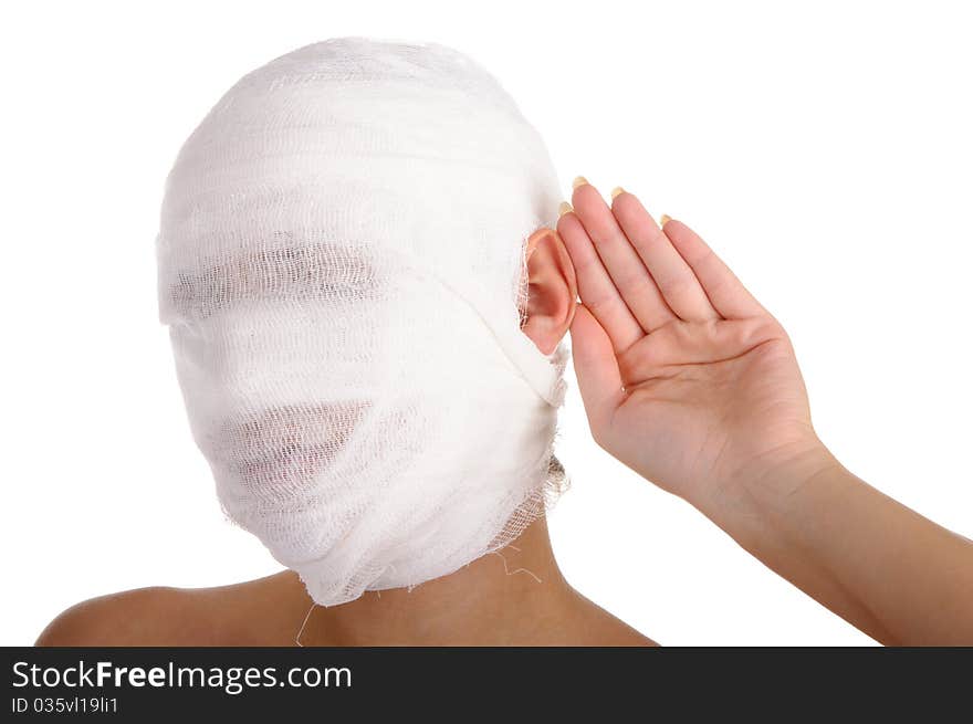 Young woman with bandaged head with palm at an ear isolated in white