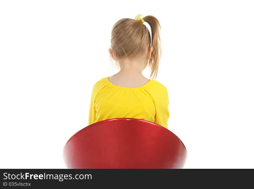 Girl sits on chair back to camera isolated in white