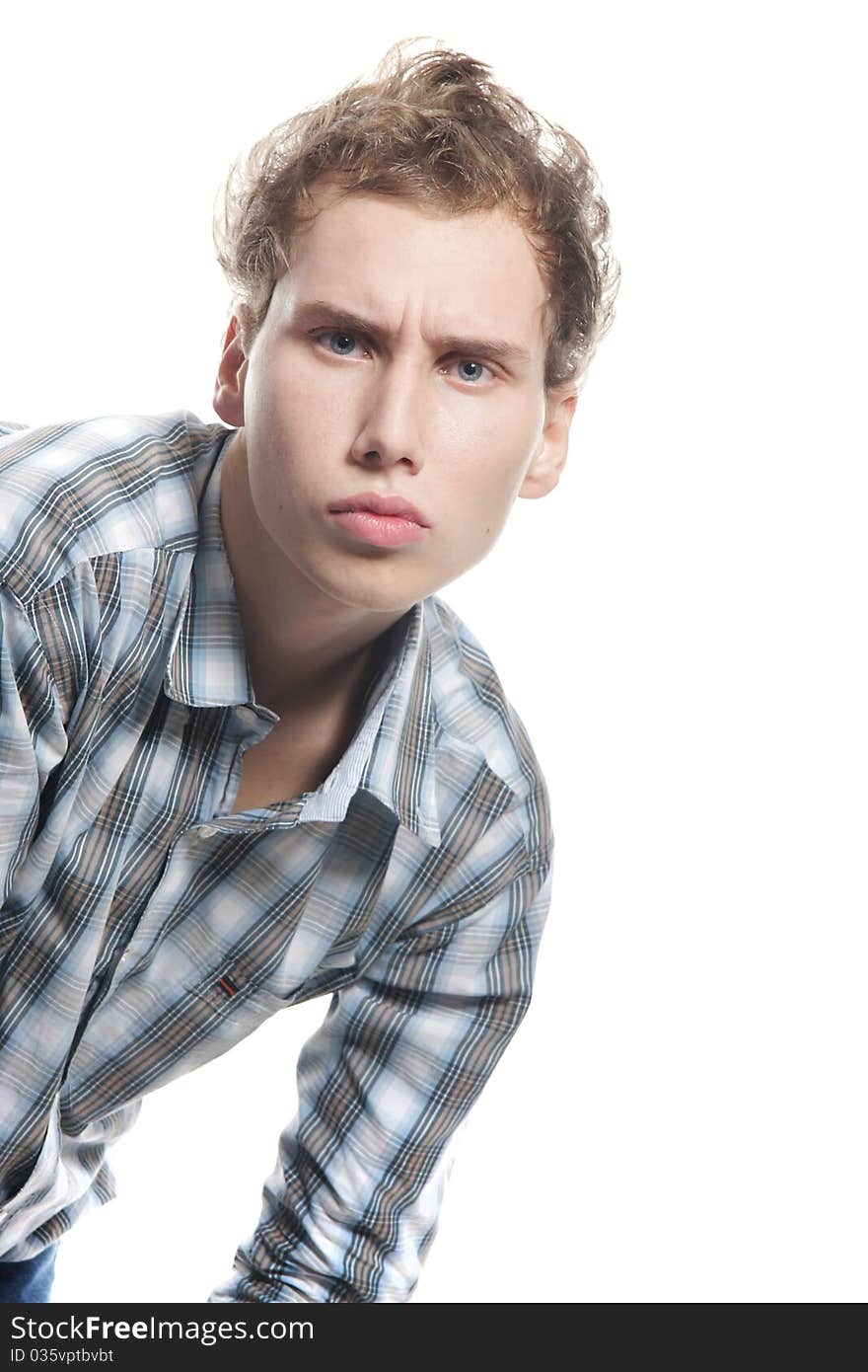 Serious young man looking straight over white