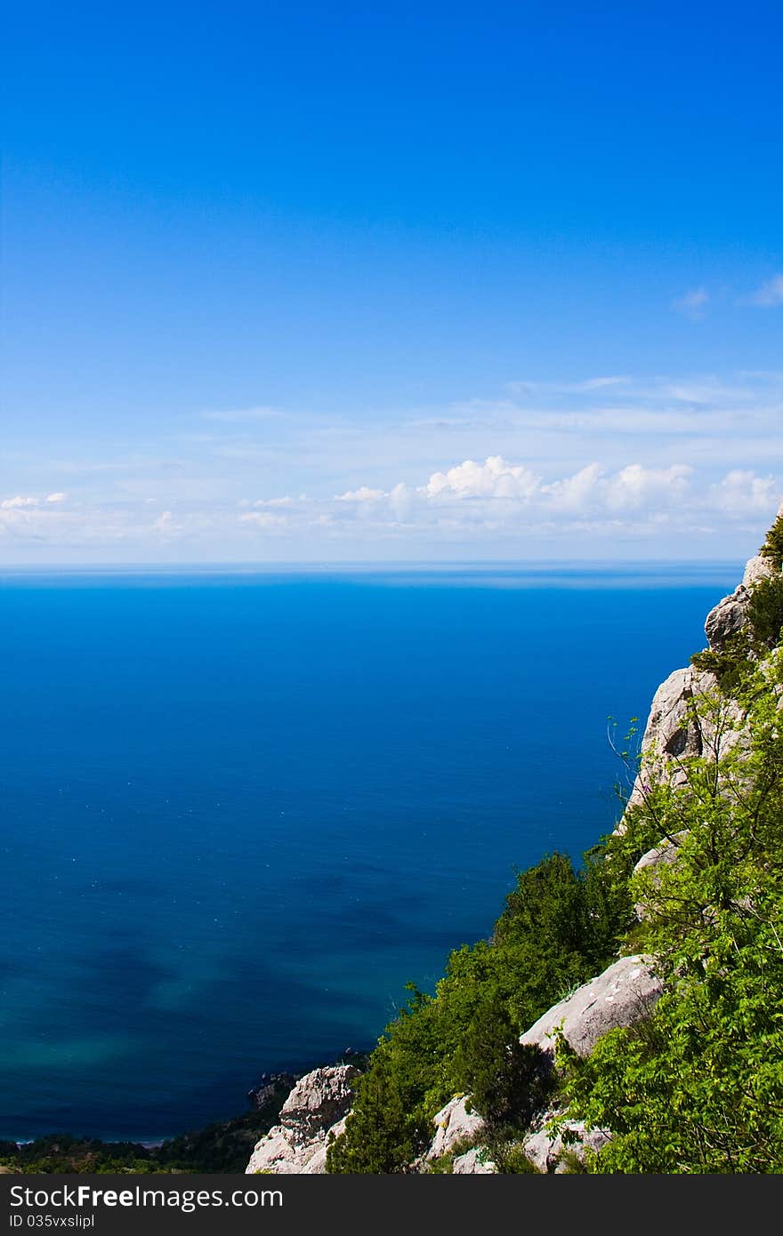 The blue sky with clouds, the sea and mountain. The blue sky with clouds, the sea and mountain