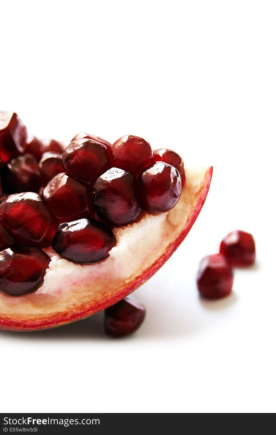 Macro of a Pomegranate section, isolated on white. Macro of a Pomegranate section, isolated on white.