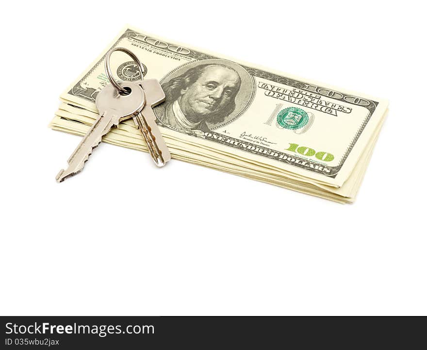 Keys and stack of dollars isolated on a white background