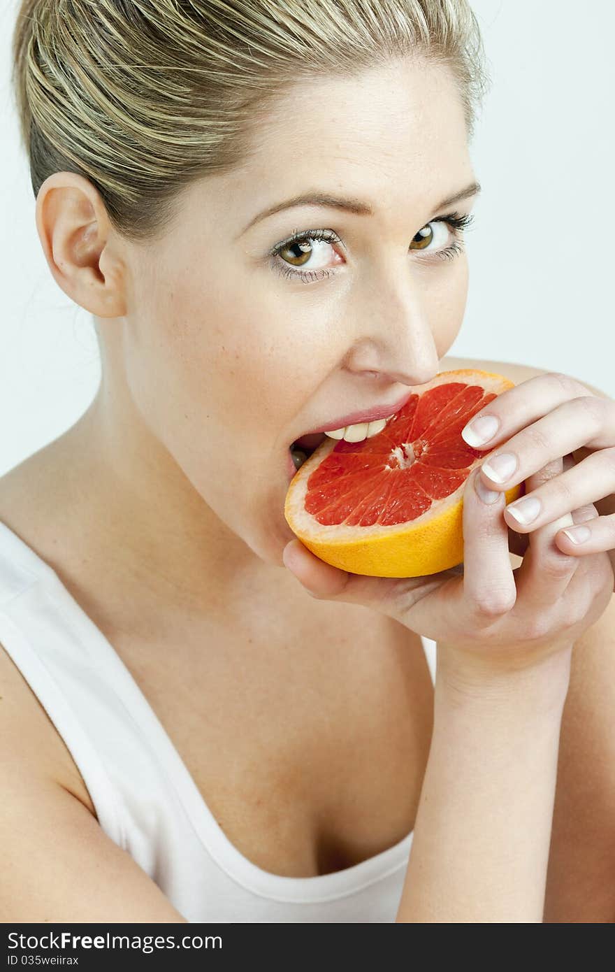 Woman Eating Grapefruit