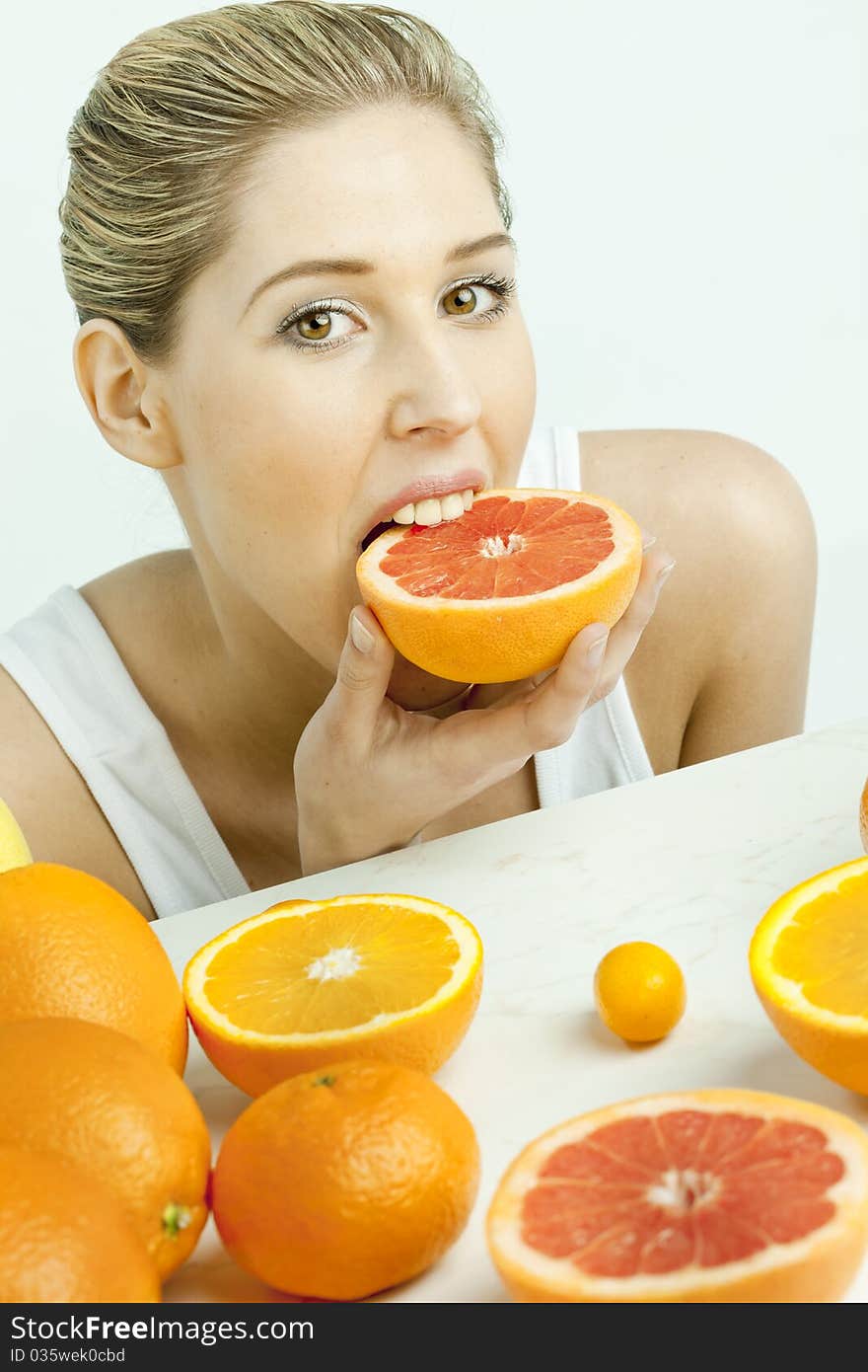 Woman eating grapefruit