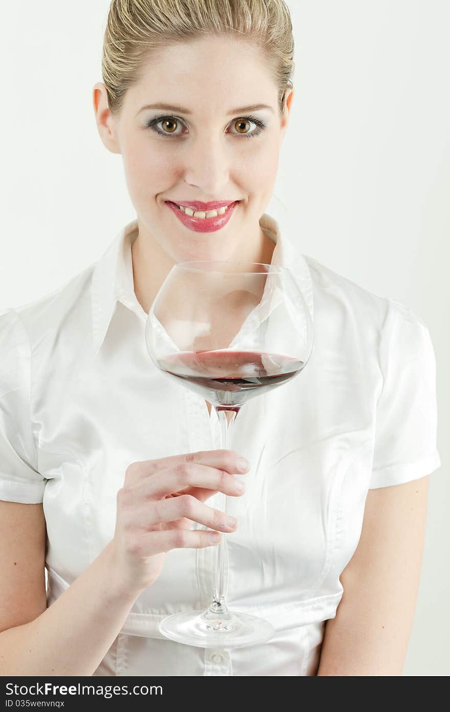 Portrait of young woman with a glass of red wine. Portrait of young woman with a glass of red wine