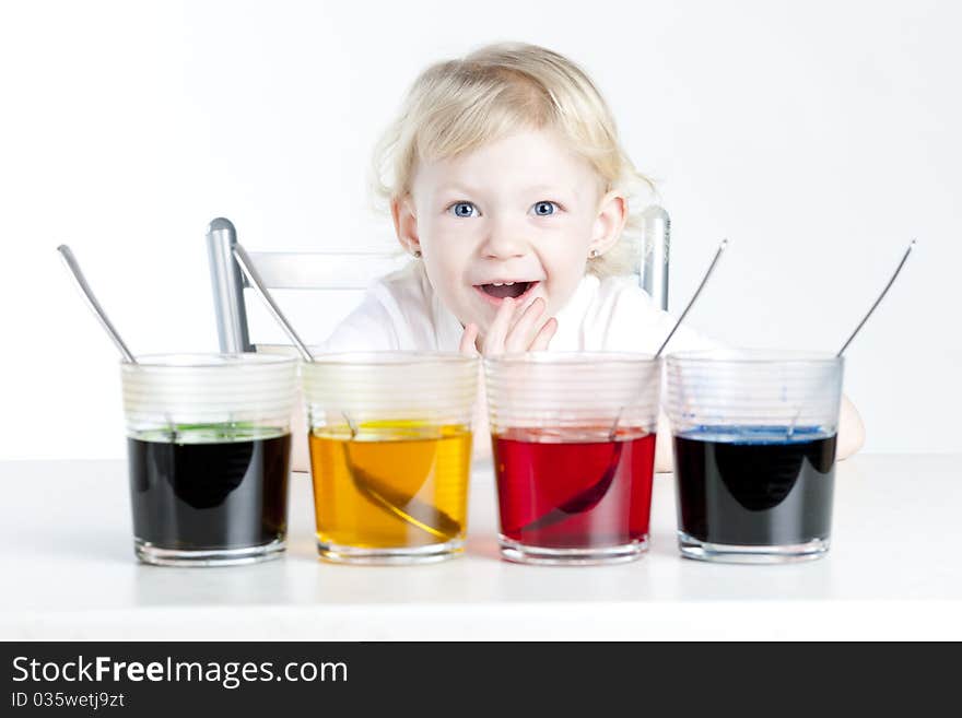 Little girl during Easter eggs' coloration