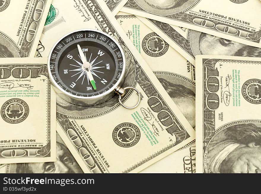 Dollars and compass. Concept about a direction in business