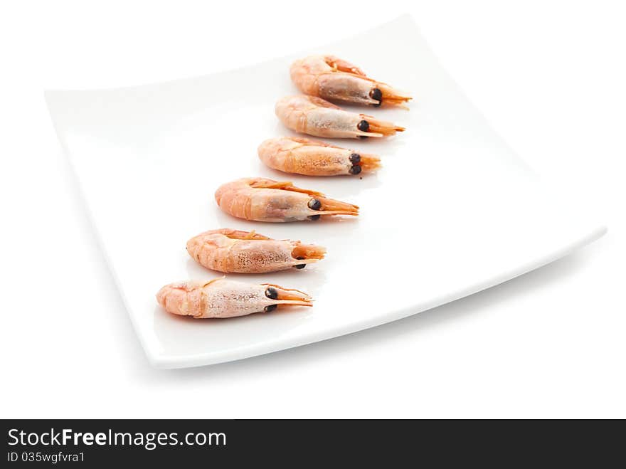 Tasty fried prawns on plate in row. Isolated on white