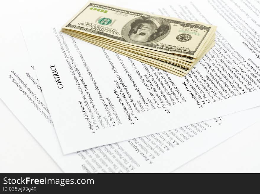 Stack hundreds dollars on contract Document background