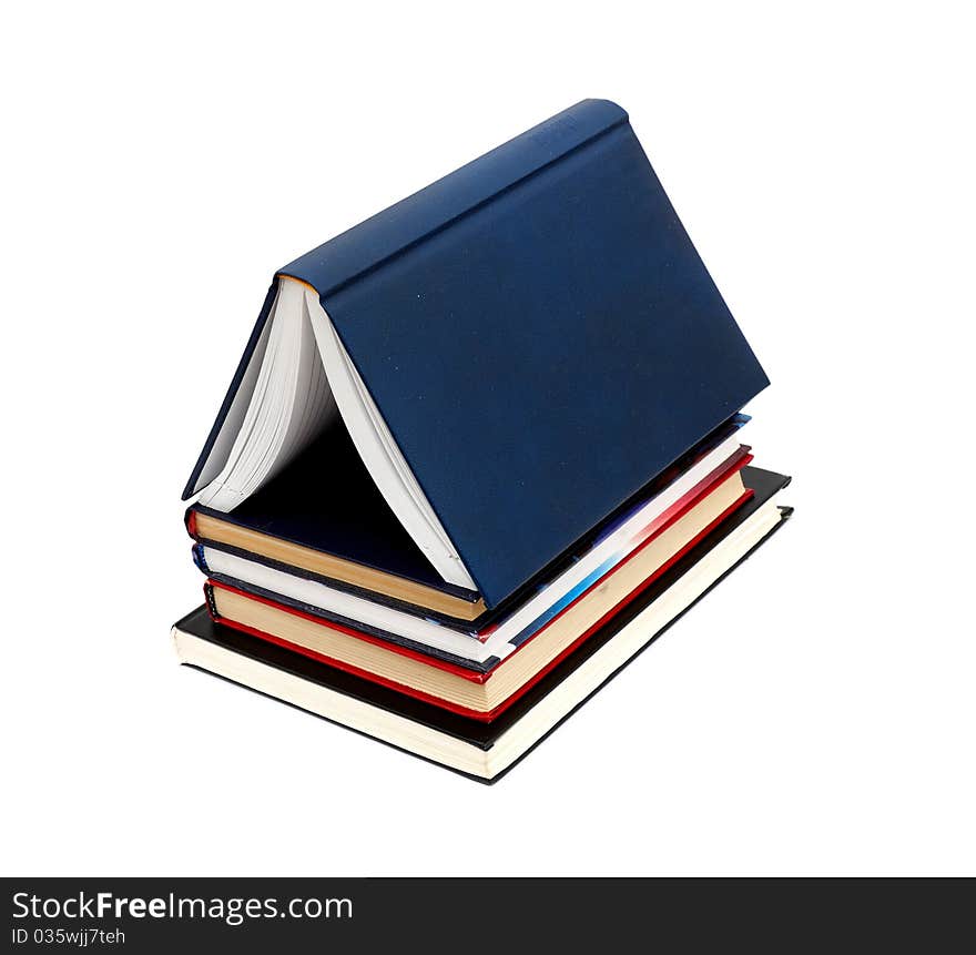 House made with books piled on white background