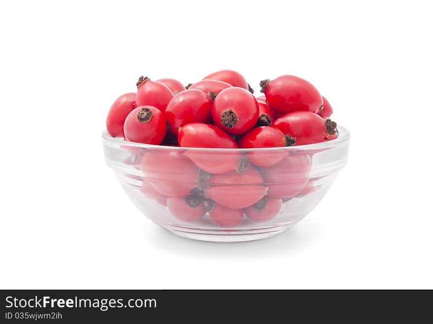 Berry wild rose in a vase on an isolated white background. Berry wild rose in a vase on an isolated white background