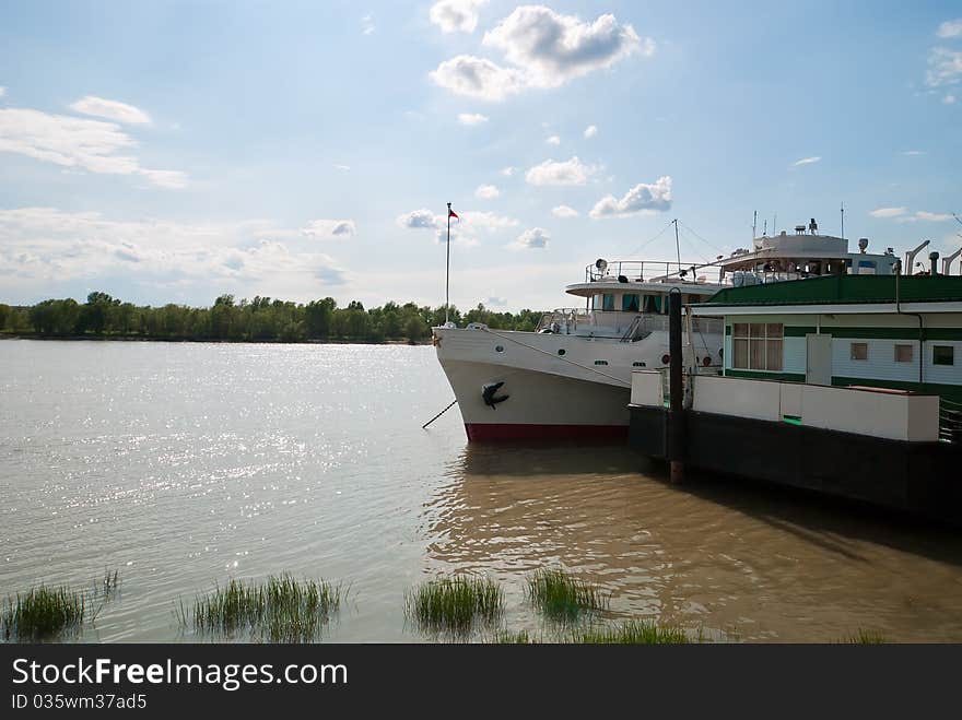 Anchored shipon the river on forest background