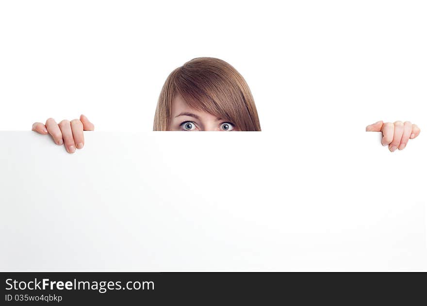 Attractive woman behind blank sign. Smiling.