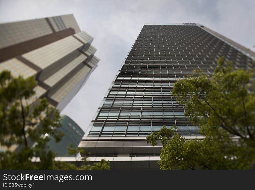 Shanghai / China: Modern office building at Shanghais Pu - Lujiazui financial district. Selective focus sharp in the center of the picture. Shanghai / China: Modern office building at Shanghais Pu - Lujiazui financial district. Selective focus sharp in the center of the picture