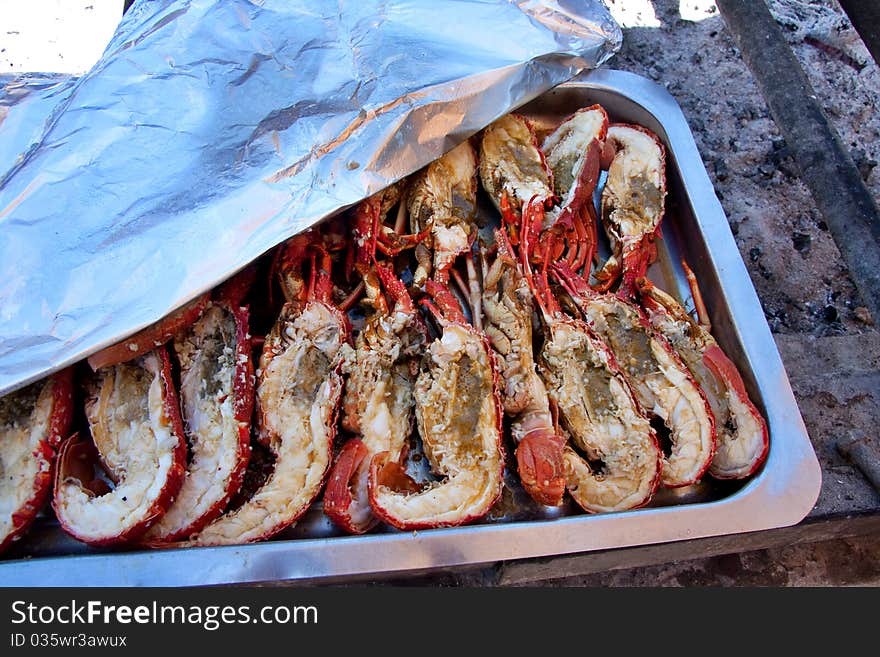 Lobsters just grilled over an open fire at an open air seaside restaurant. Lobsters just grilled over an open fire at an open air seaside restaurant