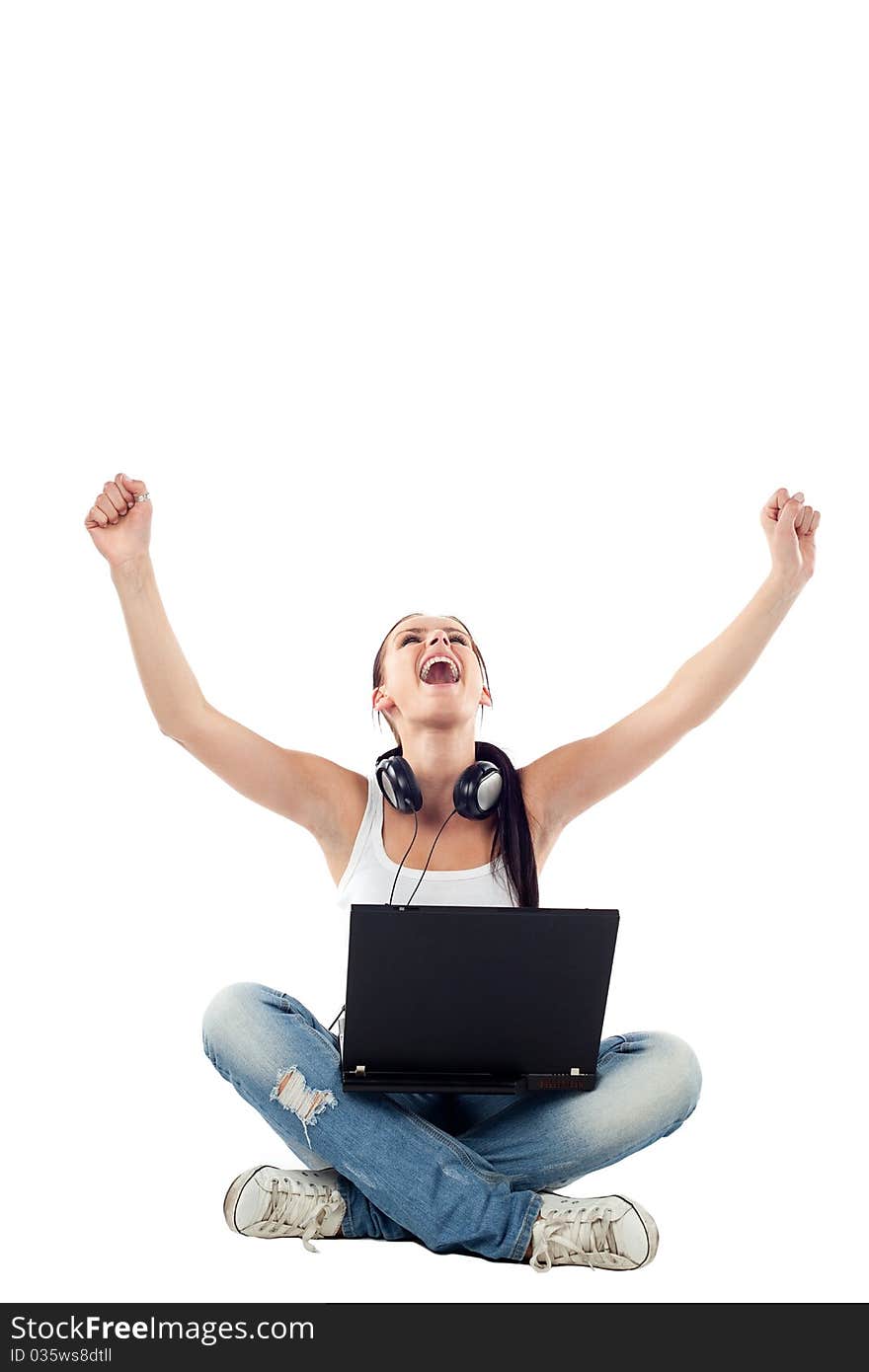 Young woman sitting with laptop raising hands. Isolated on white