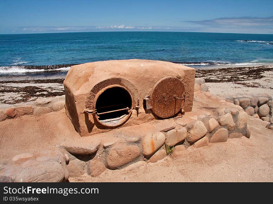 Old fashioned clay outdoor oven at the seaside for baking bread with a wood fire