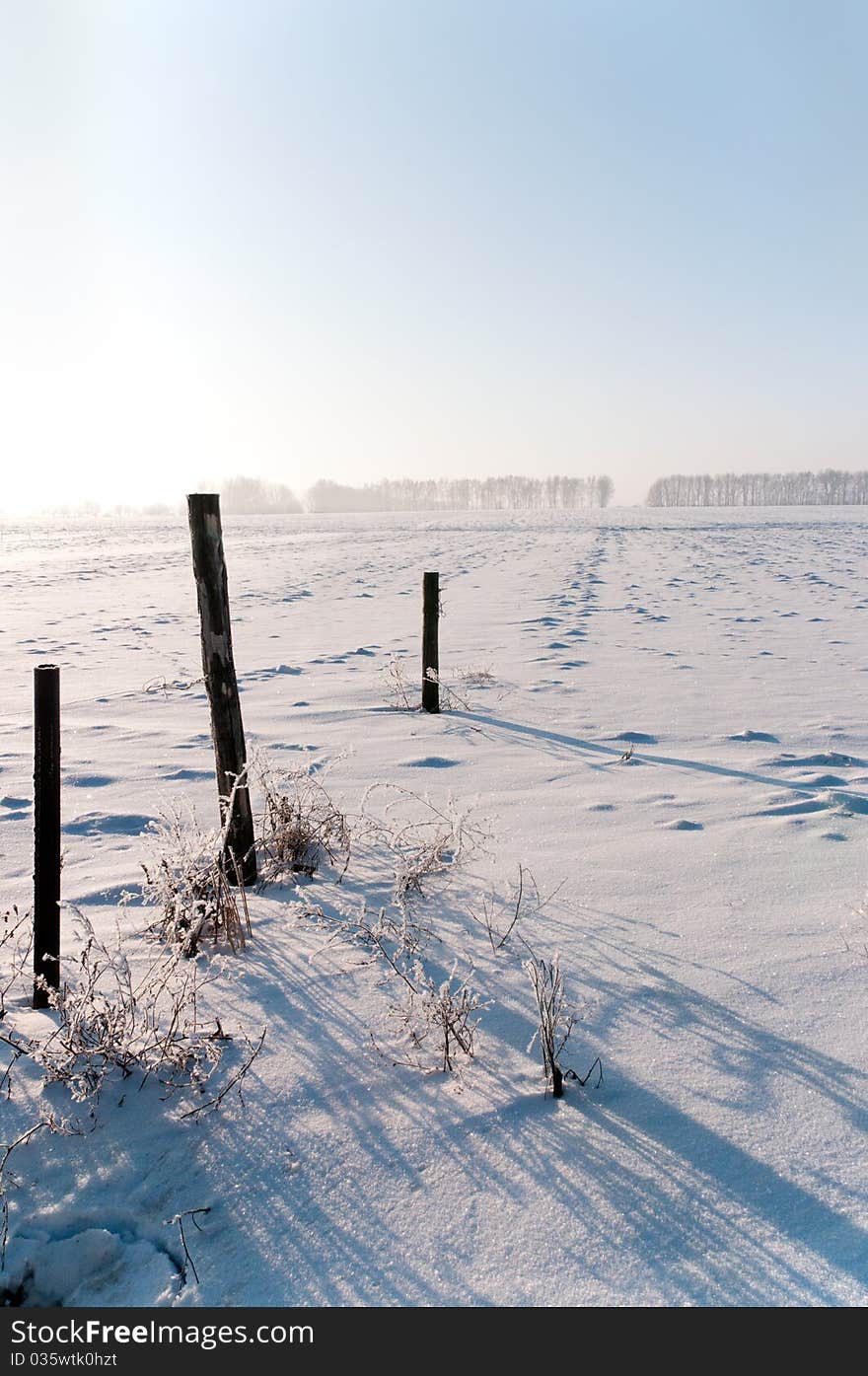 Shadows on the snow from the destroyed fence. Shadows on the snow from the destroyed fence