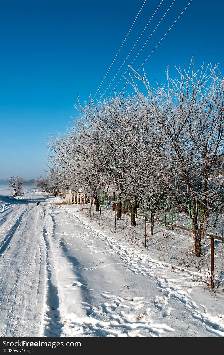 Russian village snow-covered road on a clear winter day. Russian village snow-covered road on a clear winter day