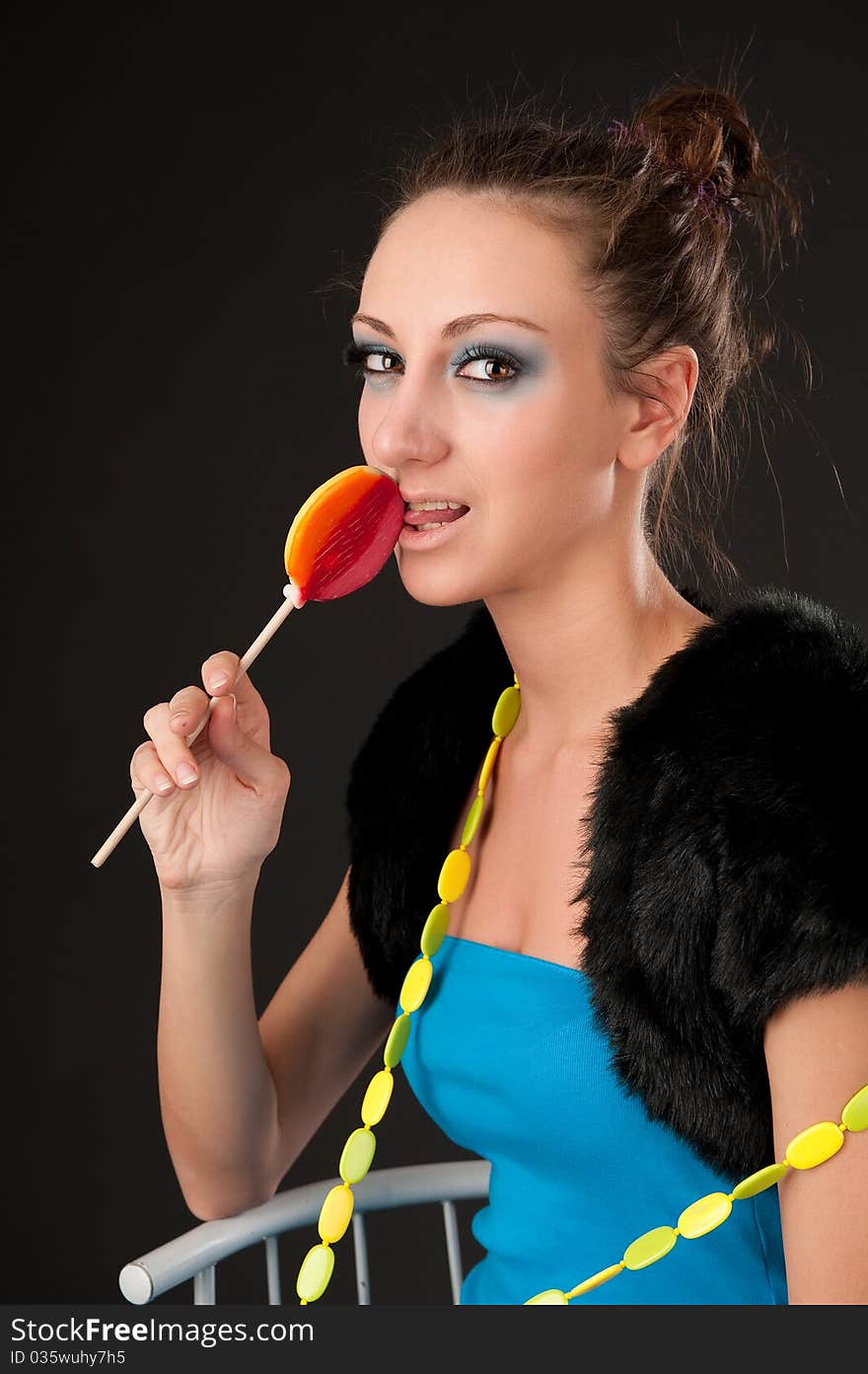 Portrait of beautiful lady with lollipop