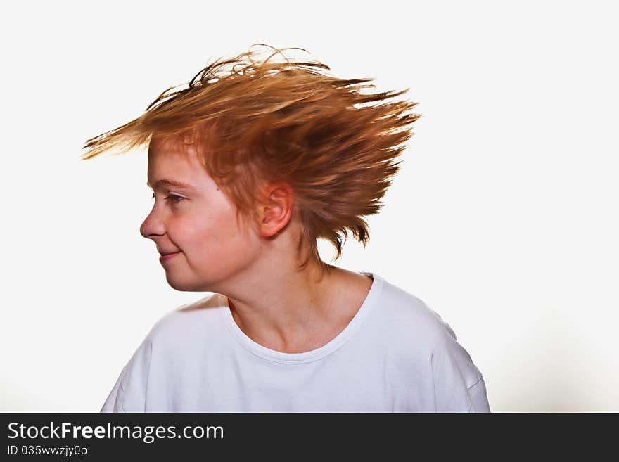 Boy has fun turning his head with flying hairs. Boy has fun turning his head with flying hairs