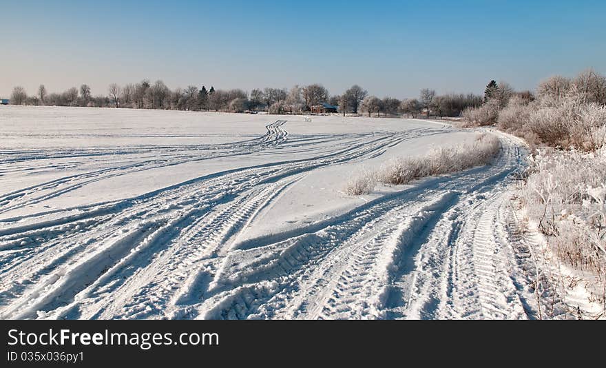 Rural roads covered with snow. Trees covered with rime. Rural roads covered with snow. Trees covered with rime