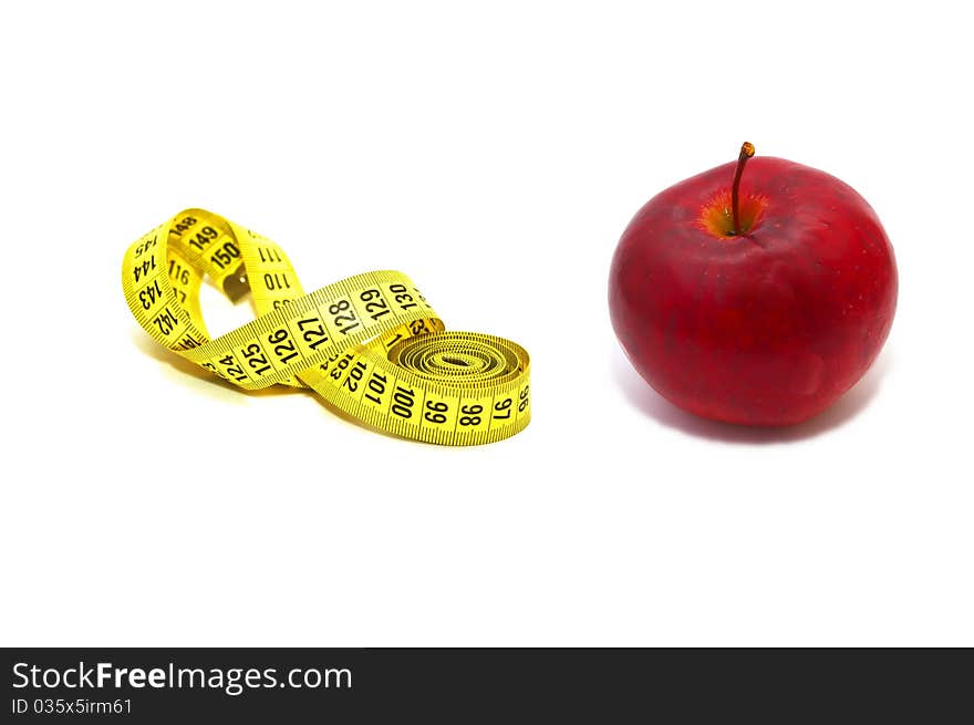 Photo of the measuring tape with red apple on white background