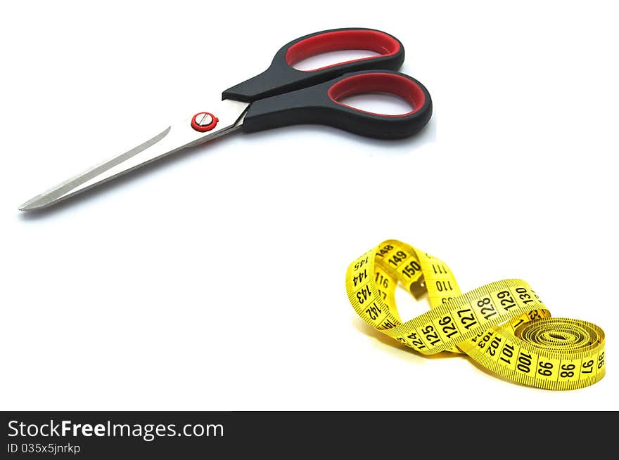 Photo of the scissors with measuring tape on white background