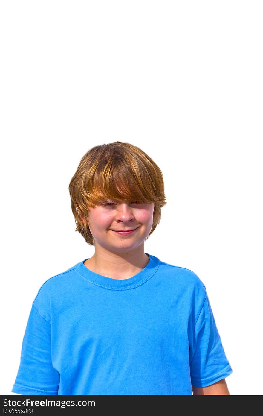 Portrait of cute young boy in sunlight with white wall