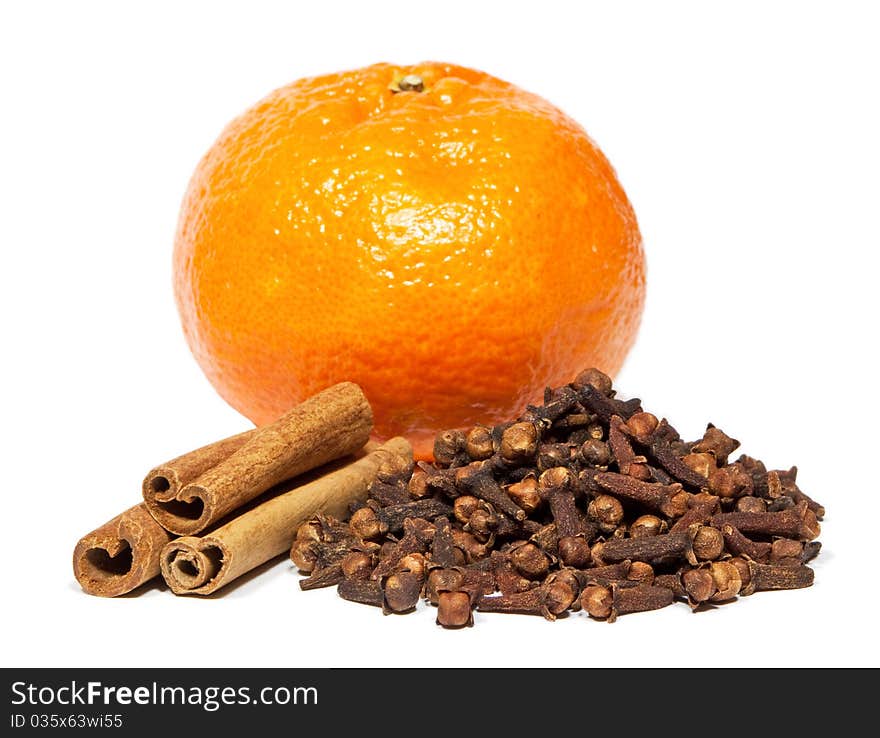 Close-up of cinnamon, clove and tangerine isolated on white background.